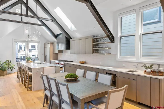 a kitchen with a table chairs stove and cabinets