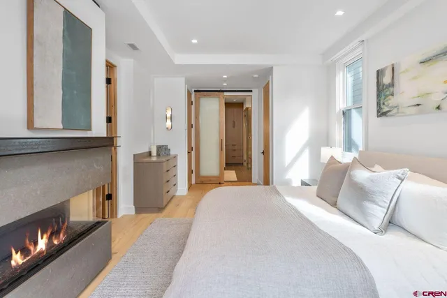 a bedroom with a bed and a fireplace