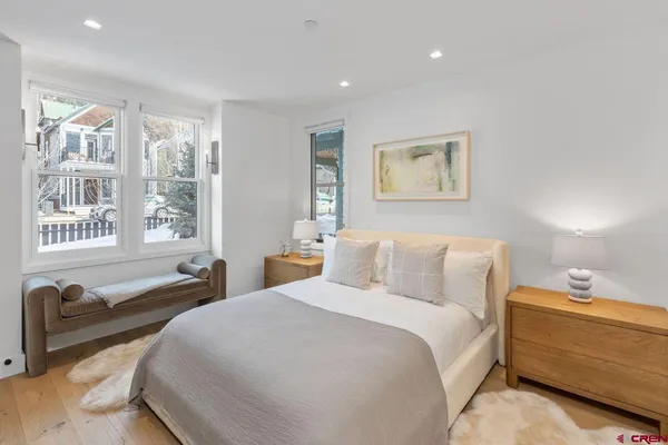 a bed room with a bed and a chair