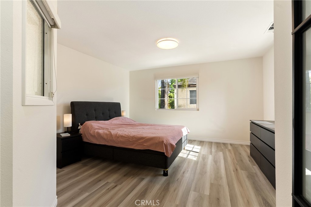 24 Rue De Nicole Lake Forest, CA 92610 - Photo 11 of 24 a bedroom with a bed and wooden floor