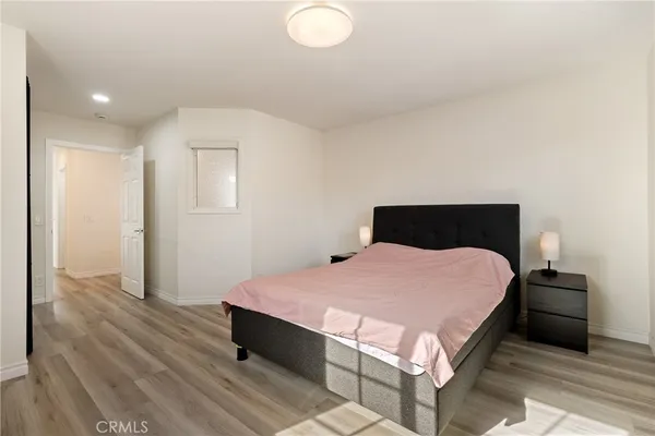 a bedroom with a bed and a night stand