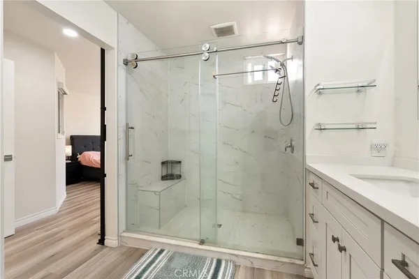 a bathroom with a shower and a sink