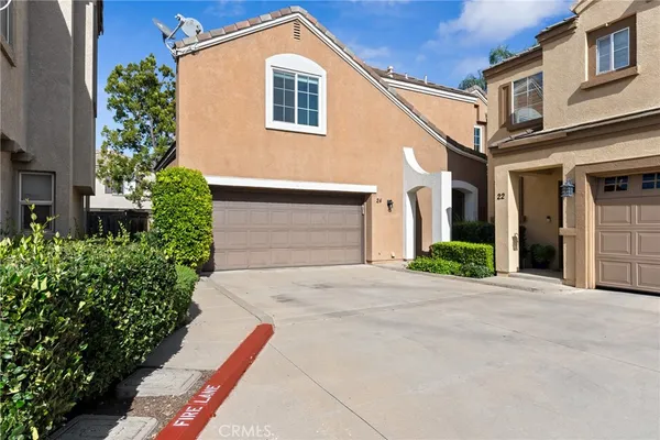 a front view of a house with a yard and a garage