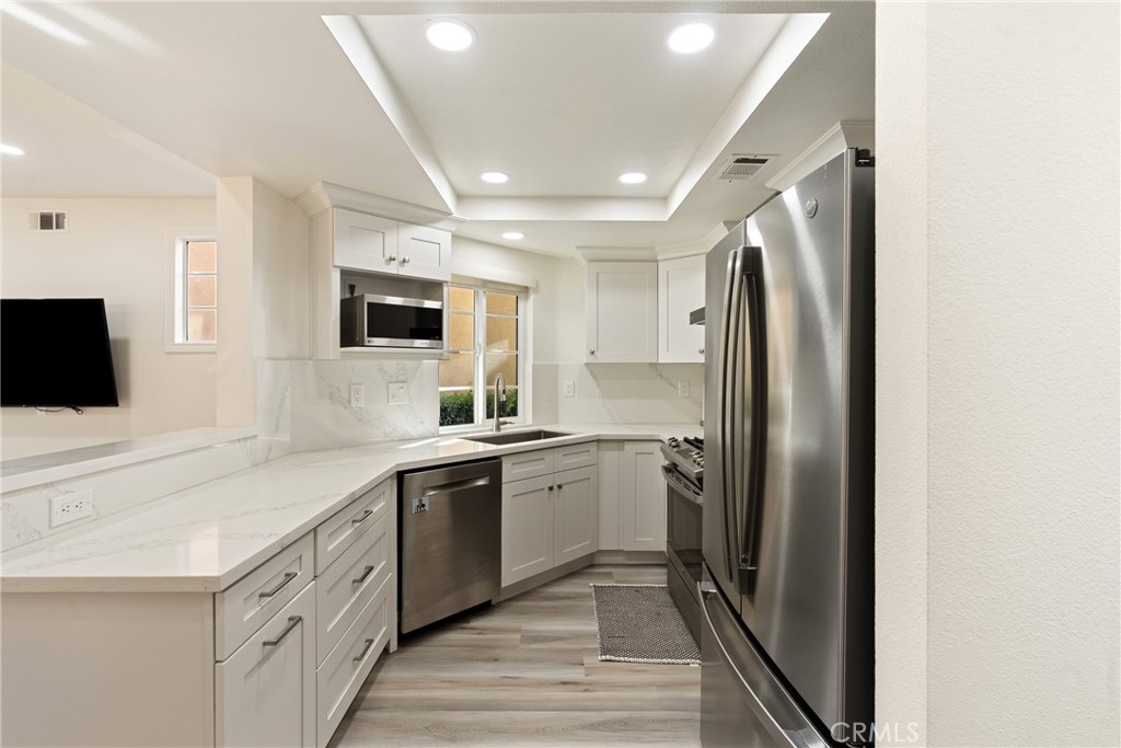 24 Rue De Nicole Lake Forest, CA 92610 - Photo 8 of 24 a kitchen with stainless steel appliances granite countertop a refrigerator and a sink