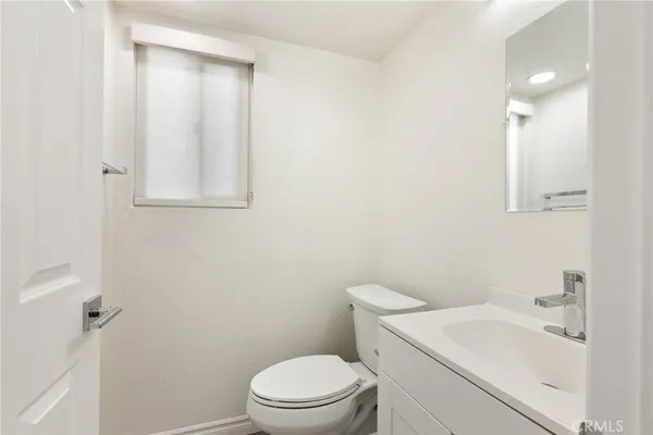 a white toilet sitting next to a bathroom sink