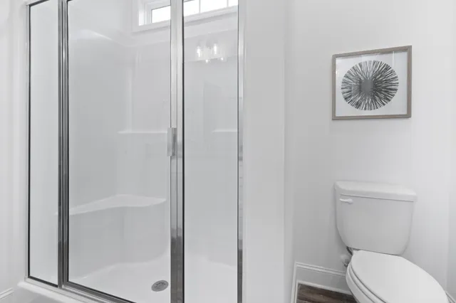a white toilet sitting next to a bathroom sink