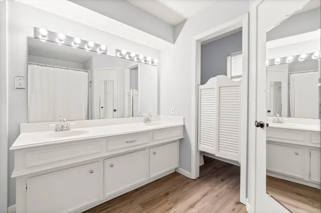 a bathroom with a double vanity sink mirror and