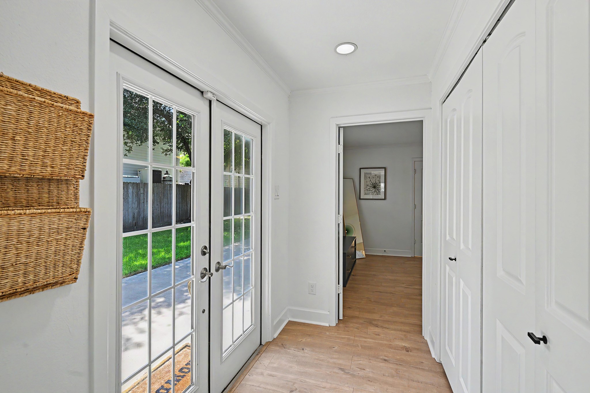 6223 Linton Road Houston, TX 77008 - Photo 13 of 30 French doors open to the backyard, primary bedroom is straight ahead and large laundry zone is behind the bi-fold doors.