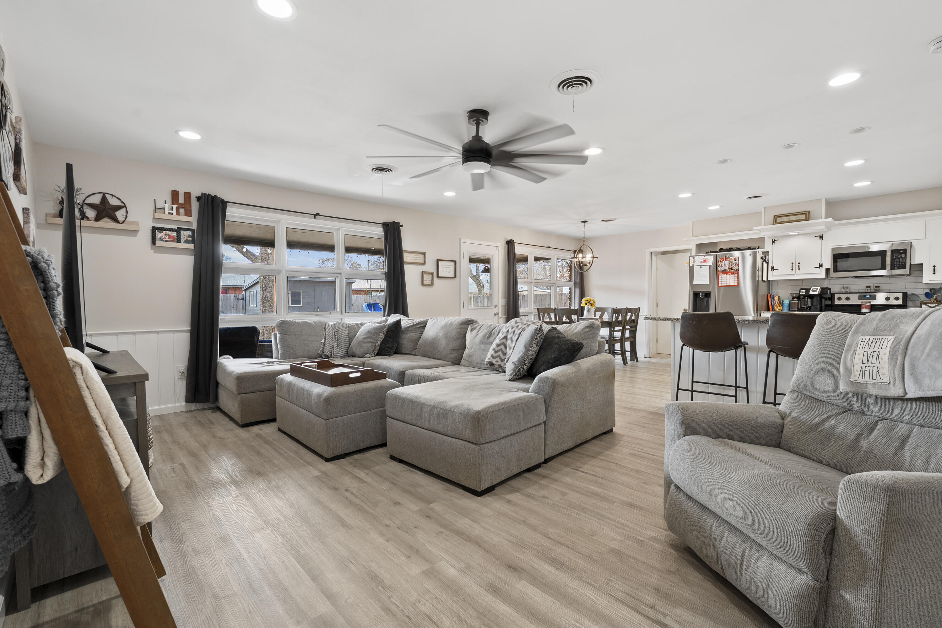 3703 41st Street Lubbock, TX 79413 - Photo 11 of 21 a living room with furniture kitchen area and a flat screen tv