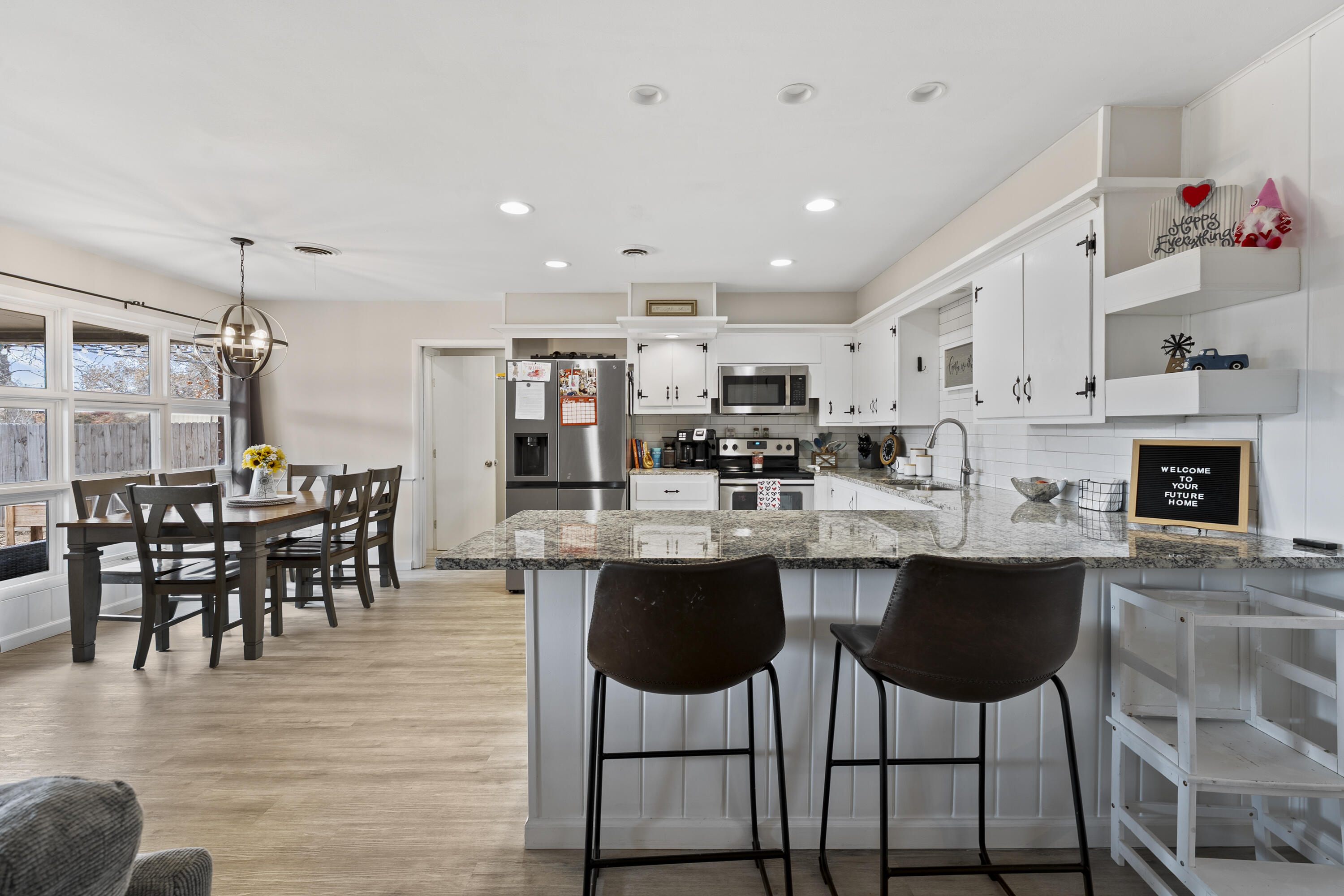 3703 41st Street Lubbock, TX 79413 - Photo 13 of 21 a kitchen with counter space cabinets dining table and chairs