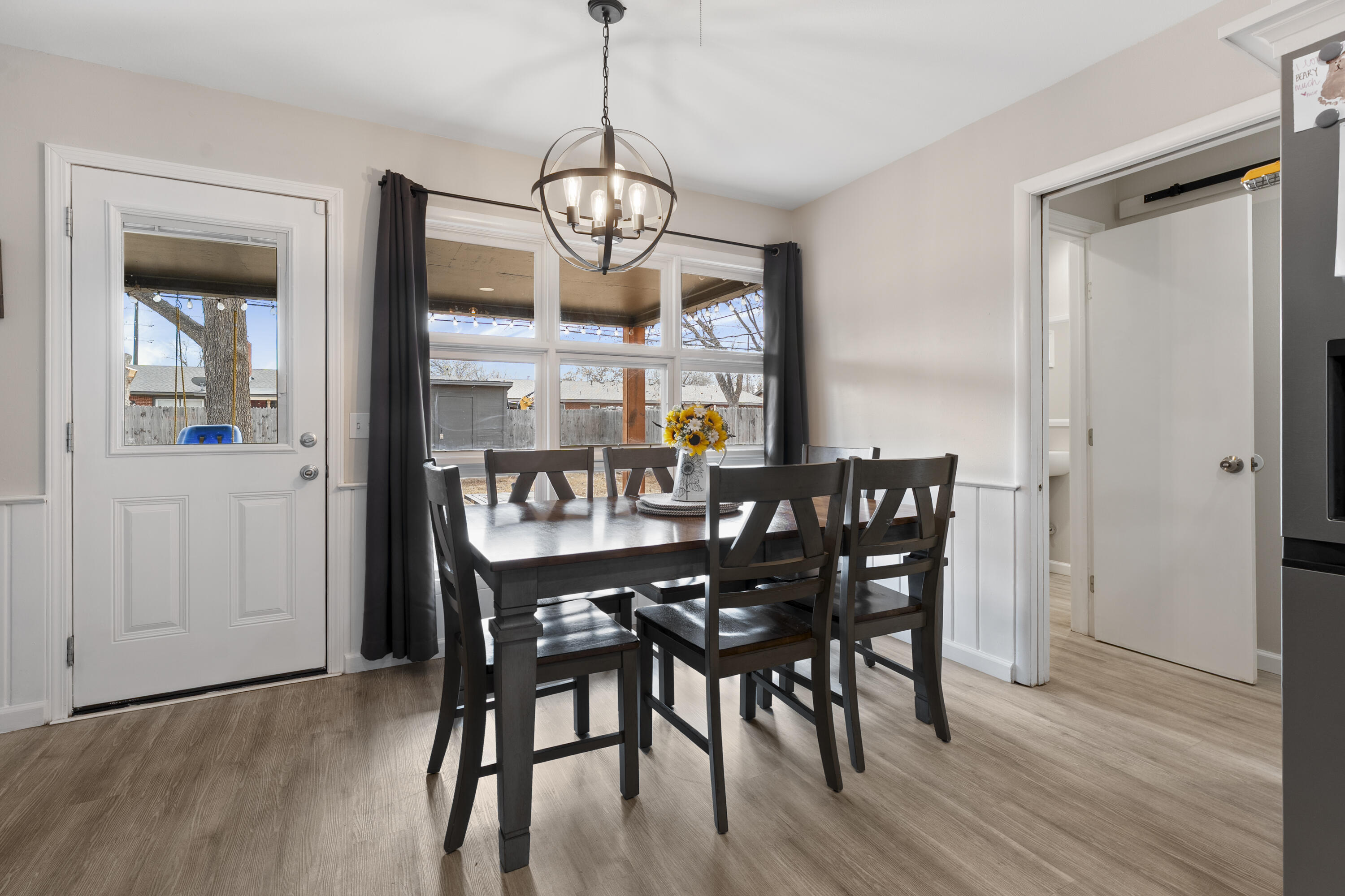 3703 41st Street Lubbock, TX 79413 - Photo 14 of 21 a view of a dining room with furniture wooden floor and chandelier