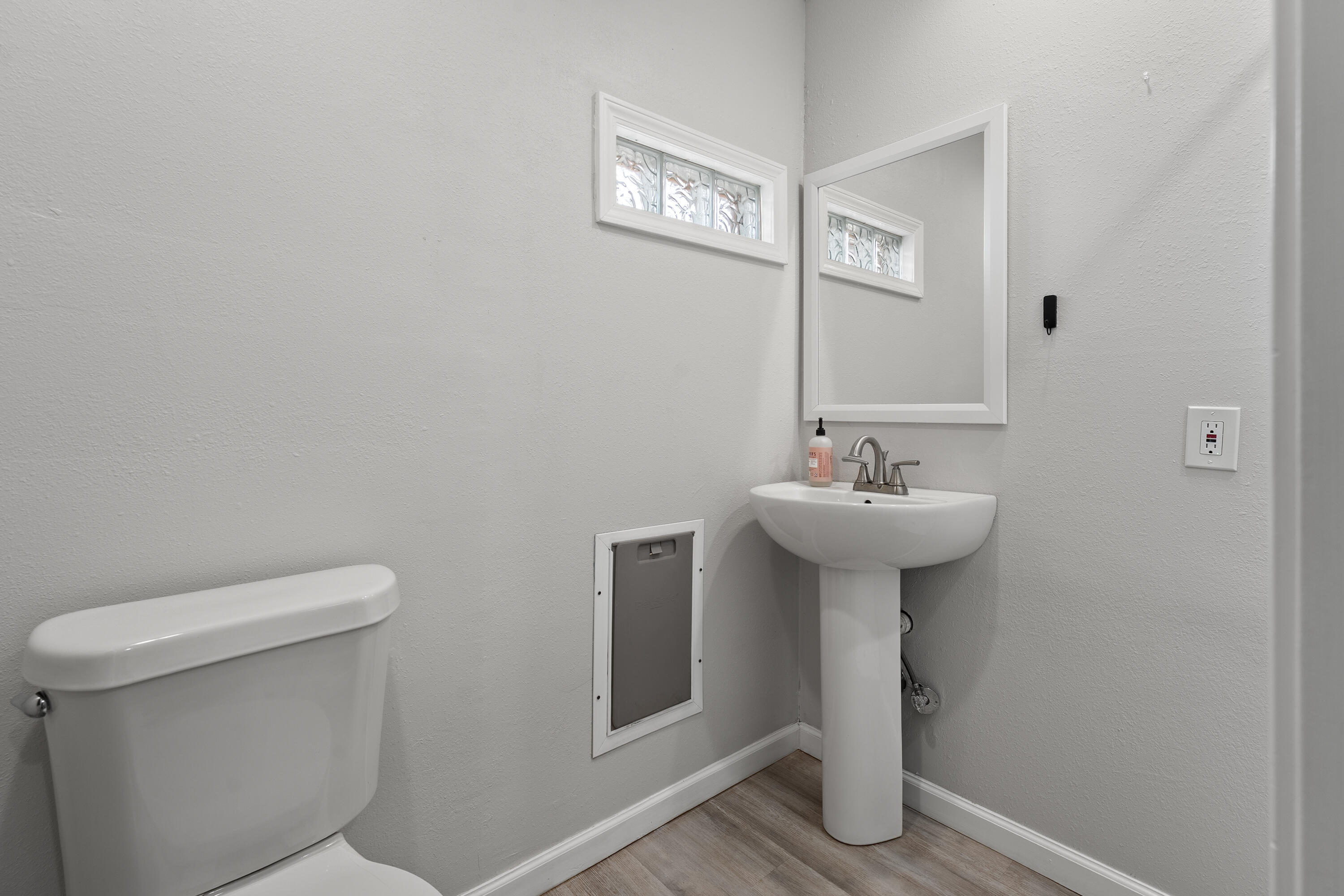 3703 41st Street Lubbock, TX 79413 - Photo 16 of 21 a bathroom with a sink a toilet and mirror