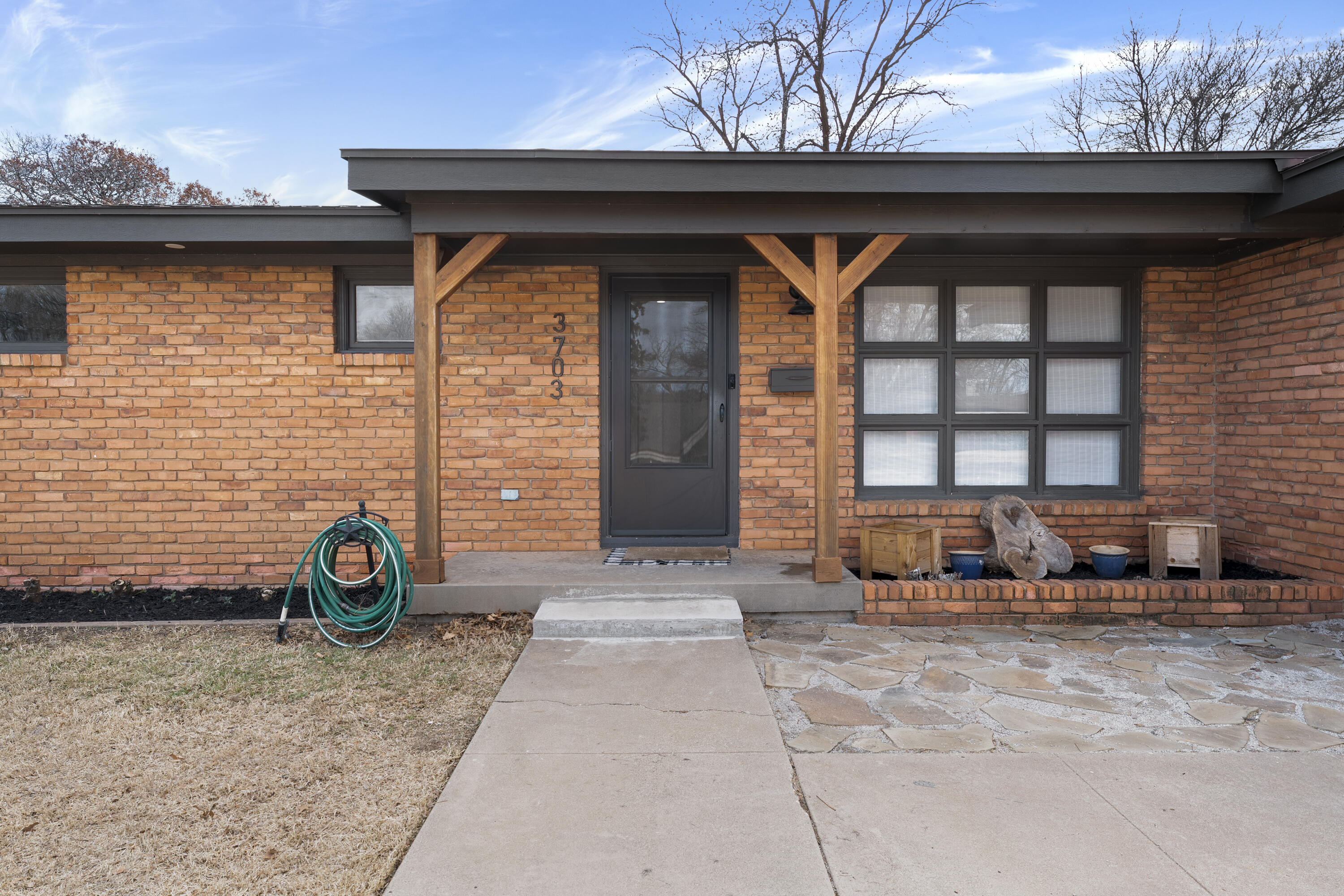 3703 41st Street Lubbock, TX 79413 - Photo 2 of 21 a front view of a house with outdoor seating