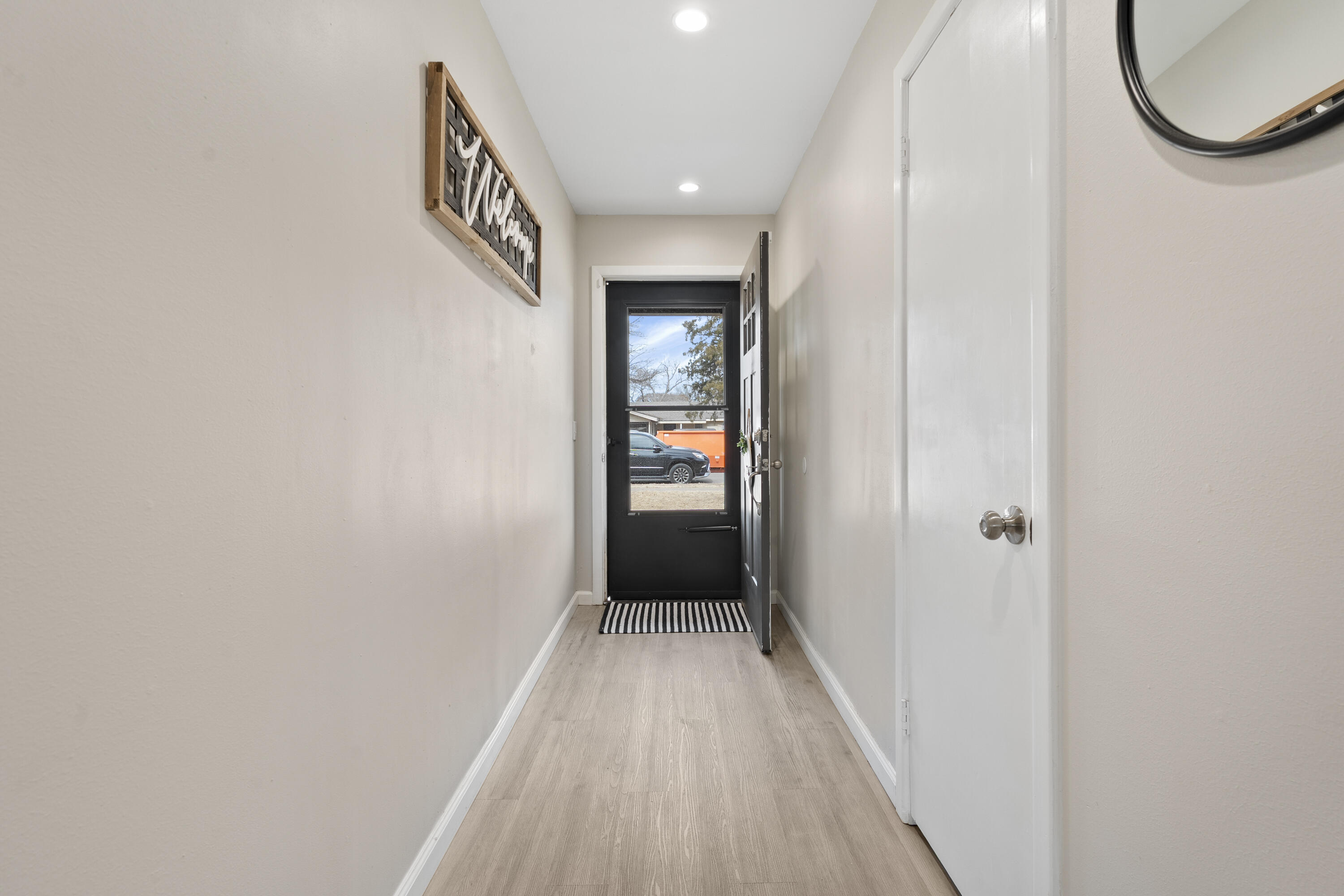 3703 41st Street Lubbock, TX 79413 - Photo 3 of 21 a view of a hallway with wooden floor and a bathroom