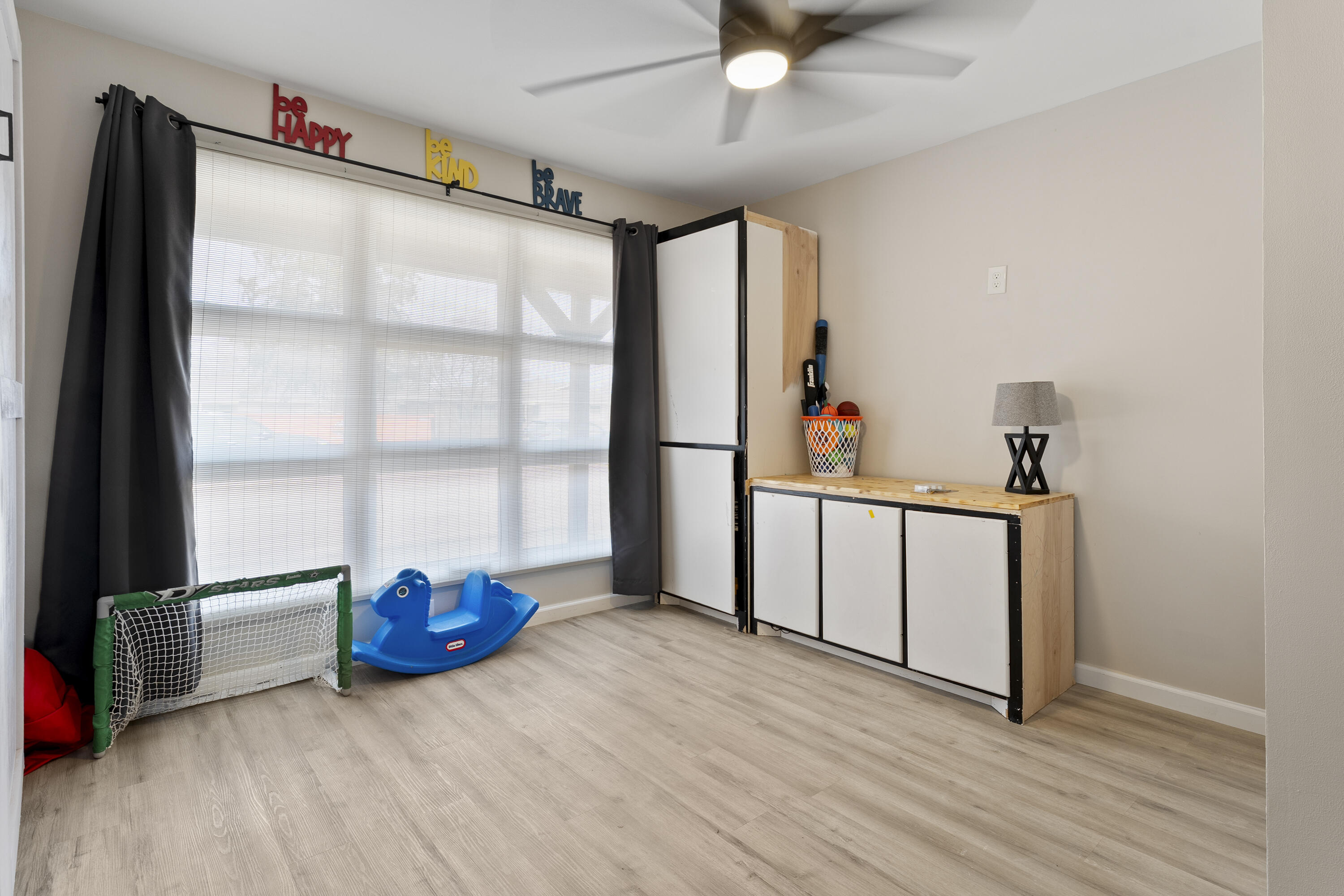 3703 41st Street Lubbock, TX 79413 - Photo 4 of 21 a view of an empty room with a window and wooden floor