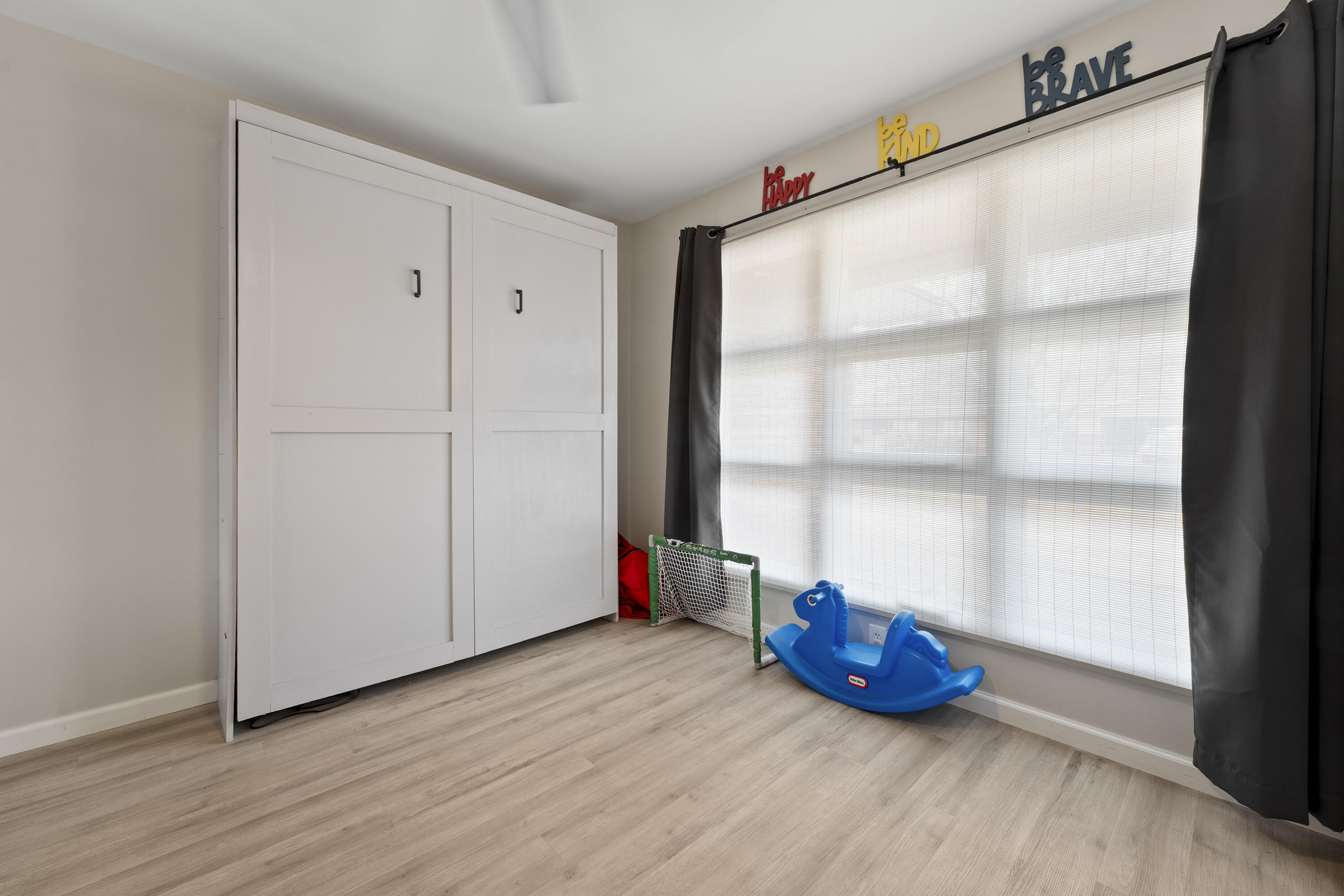 3703 41st Street Lubbock, TX 79413 - Photo 5 of 21 a view of empty room with wooden floor and fan