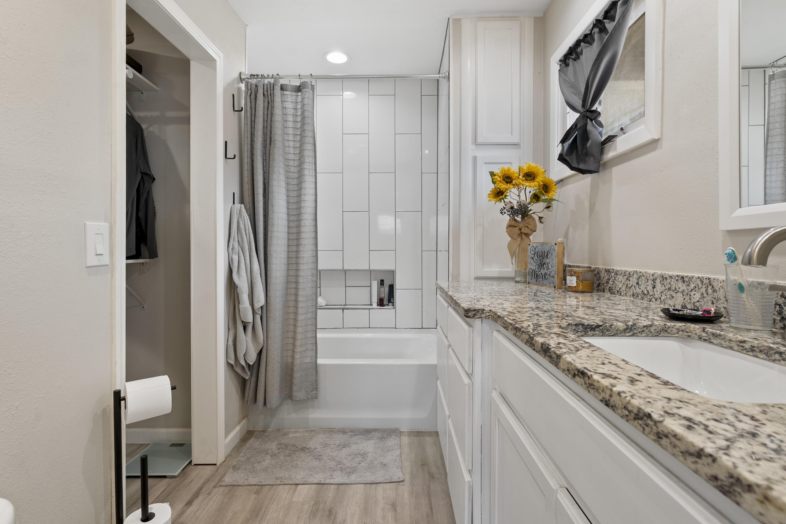 3703 41st Street Lubbock, TX 79413 - Photo 10 of 21 a bathroom with a granite countertop sink a mirror and shower