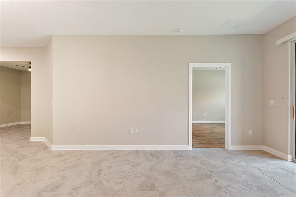 1064 Blackwolf Run Road Davenport, FL 33896 - Photo 11 of 38 an empty room with an entryway