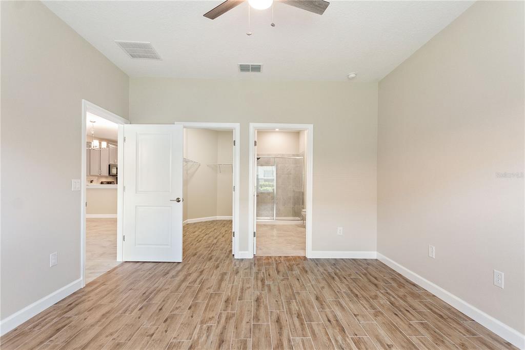 1064 Blackwolf Run Road Davenport, FL 33896 - Photo 13 of 38 wooden floor in an empty room