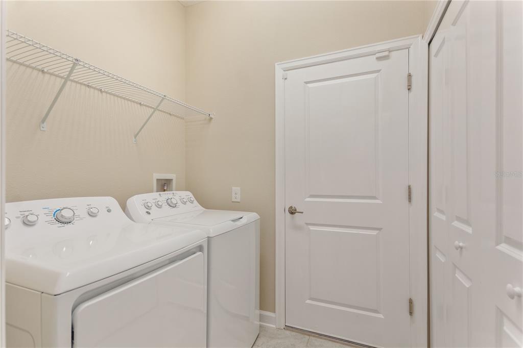 1064 Blackwolf Run Road Davenport, FL 33896 - Photo 17 of 38 a utility room with dryer and washer