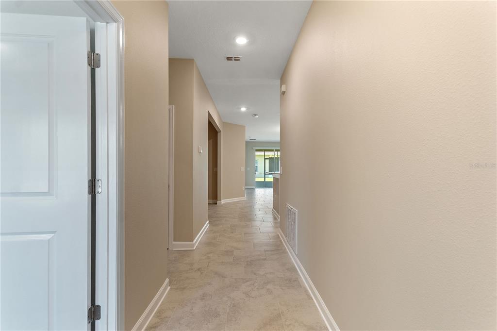 1064 Blackwolf Run Road Davenport, FL 33896 - Photo 5 of 38 a view of a hallway with wooden floor