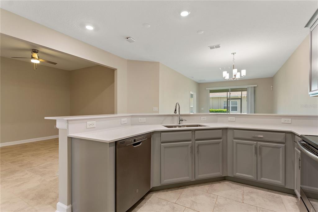 1064 Blackwolf Run Road Davenport, FL 33896 - Photo 6 of 38 a kitchen with a sink and cabinets