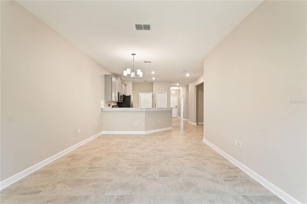 1064 Blackwolf Run Road Davenport, FL 33896 - Photo 10 of 38 a view of a kitchen with a sink and a chandelier