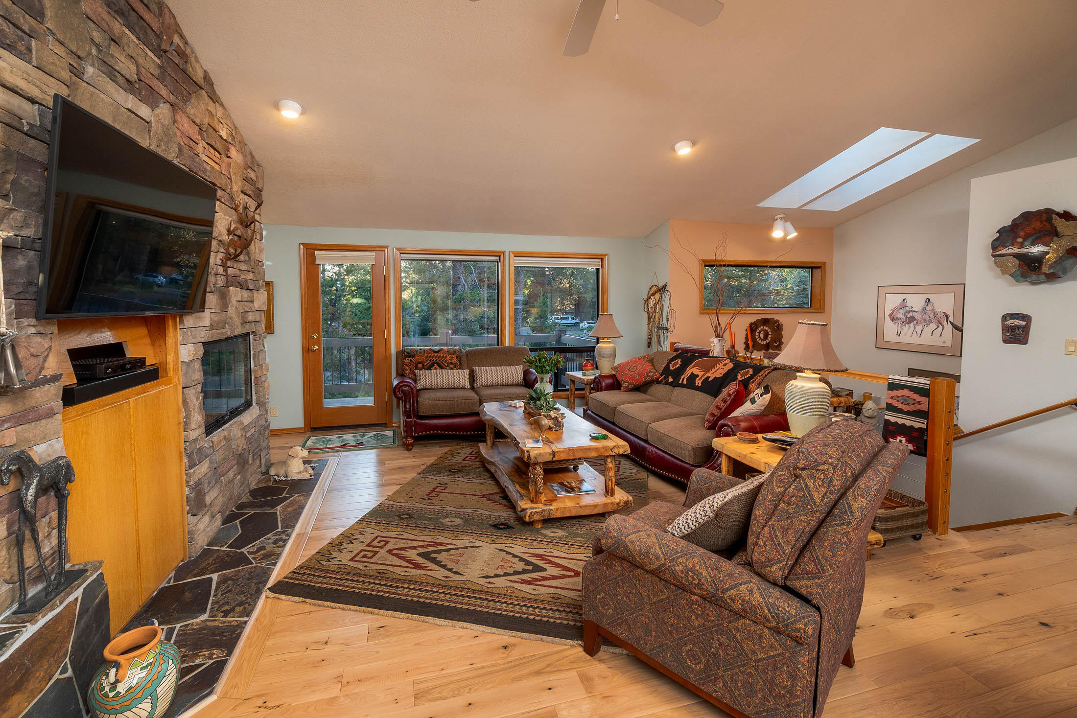 18203 Oregon Loop, Unit 45 Sunriver, OR 97707 - Photo 6 of 33 a living room with furniture a flat screen tv and a refrigerator