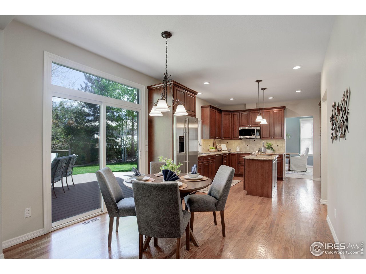 5218 Pinehurst Drive Boulder, CO 80301 - Photo 11 of 39 a view of a dining room and livingroom with furniture wooden floor a chandelier