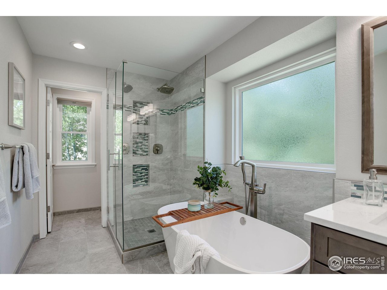 5218 Pinehurst Drive Boulder, CO 80301 - Photo 18 of 39 a bathroom with a tub sink and mirror