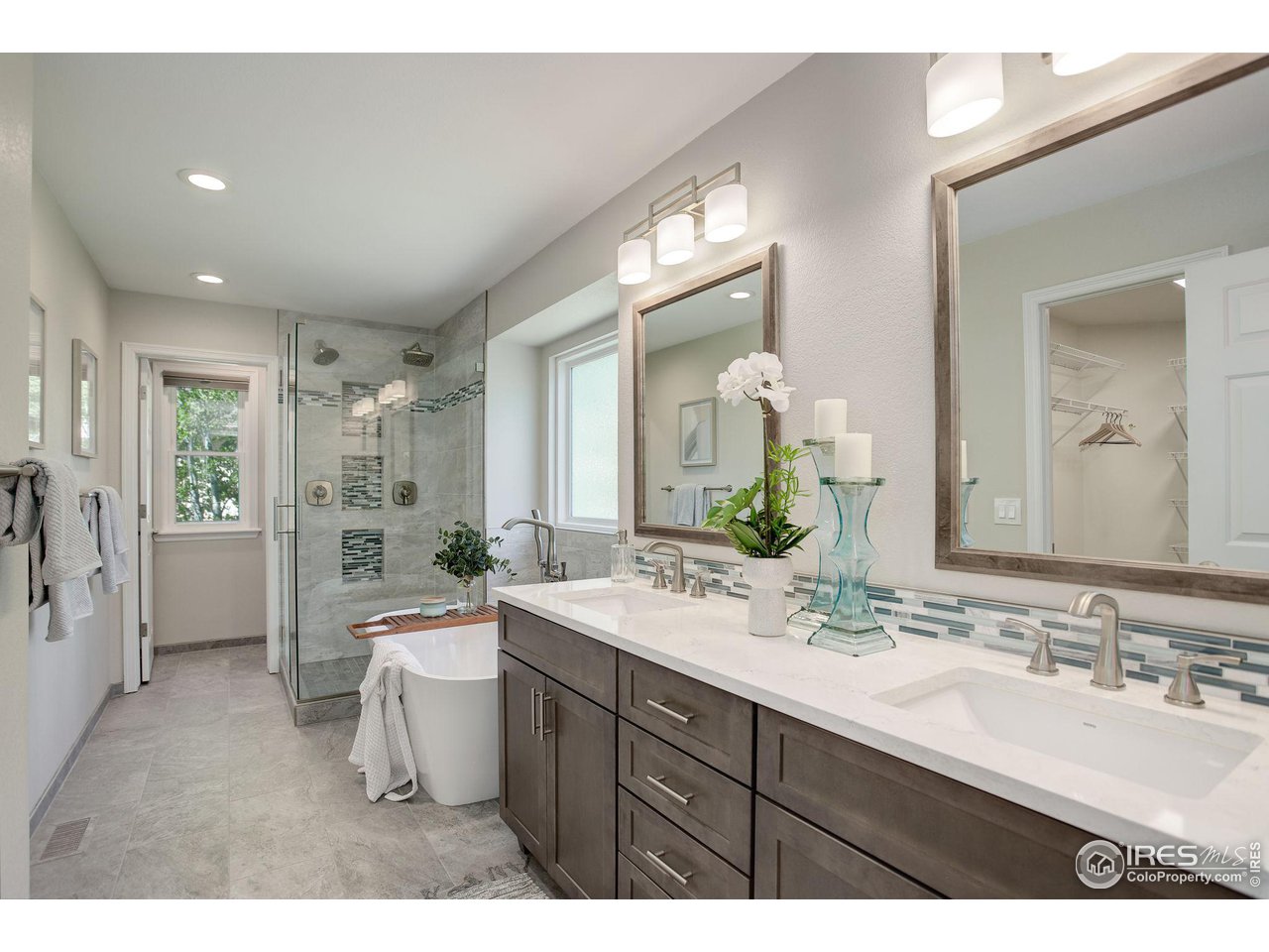 5218 Pinehurst Drive Boulder, CO 80301 - Photo 19 of 39 a bathroom with a double vanity sink a mirror and a bathtub
