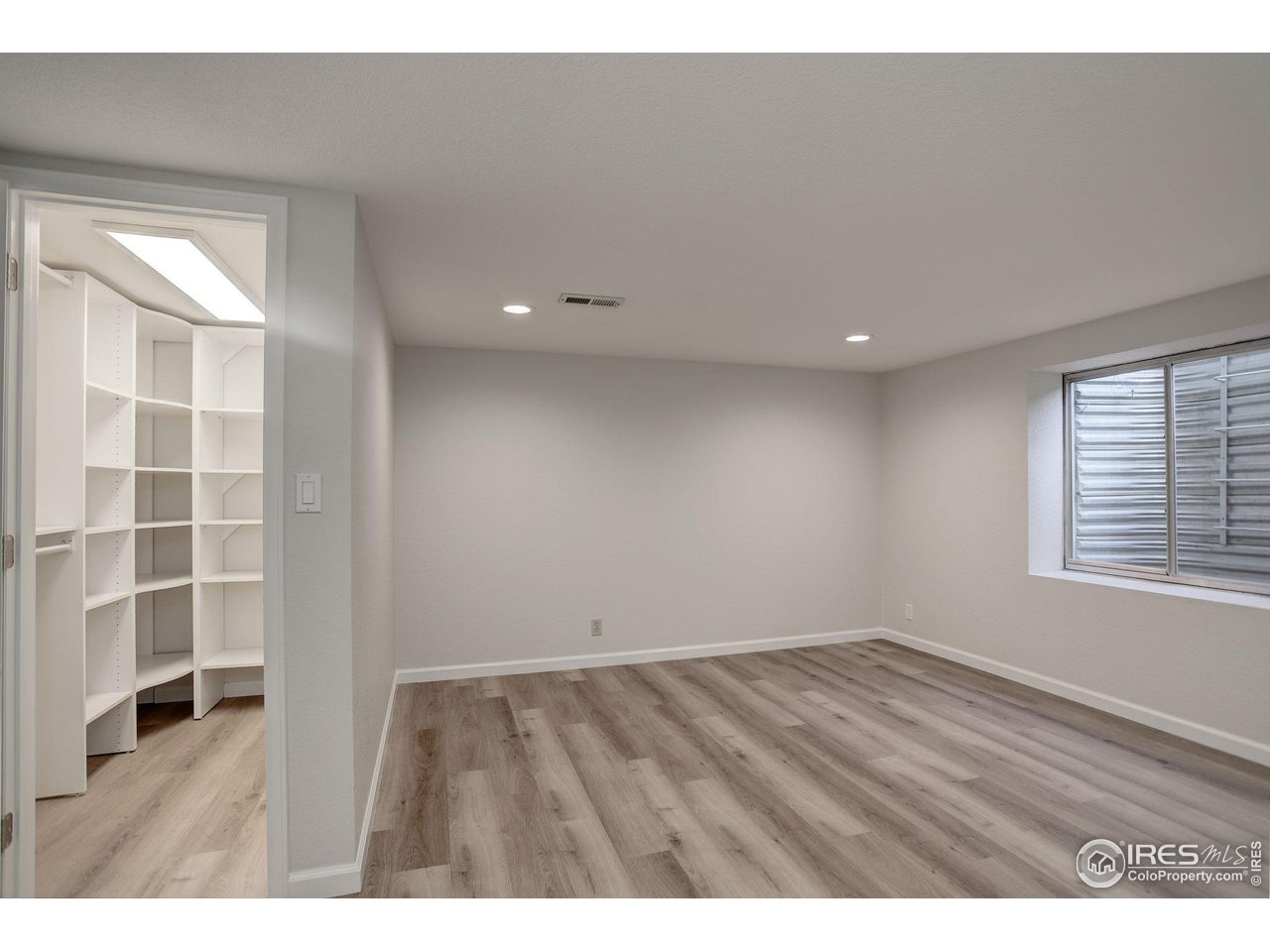 5218 Pinehurst Drive Boulder, CO 80301 - Photo 30 of 39 a view of an empty room with a window and wooden floor