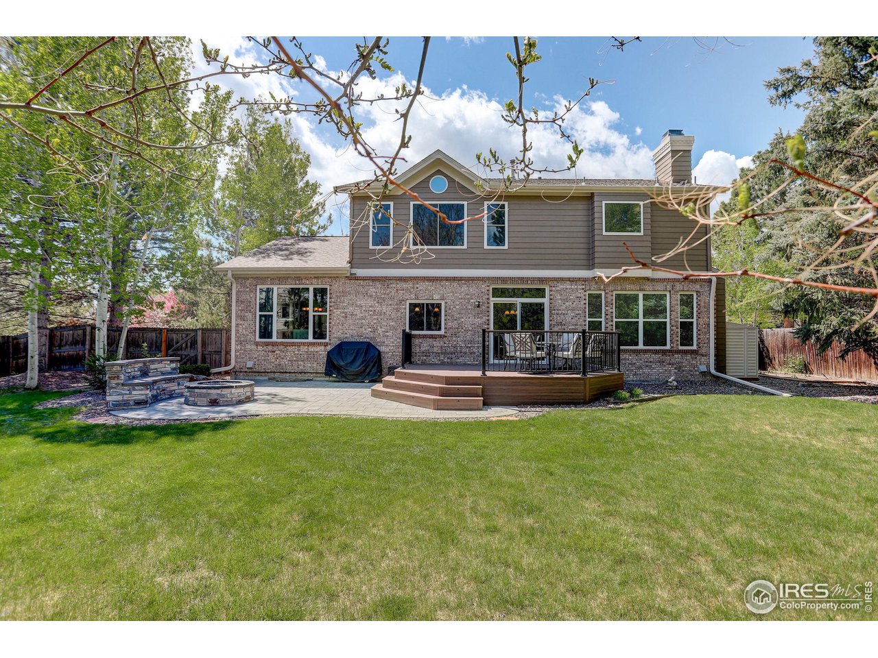 5218 Pinehurst Drive Boulder, CO 80301 - Photo 32 of 39 a view of a house with a big yard potted plants and large tree