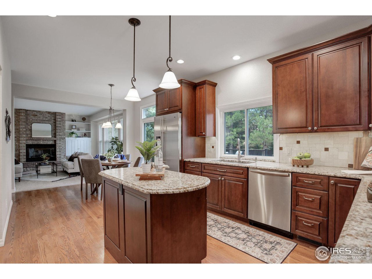 5218 Pinehurst Drive Boulder, CO 80301 - Photo 9 of 39 a kitchen with kitchen island granite countertop a sink window and cabinets