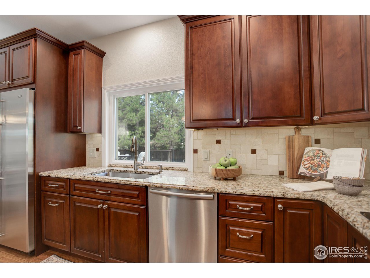 5218 Pinehurst Drive Boulder, CO 80301 - Photo 10 of 39 a kitchen with granite countertop stainless steel appliances a sink window and cabinets