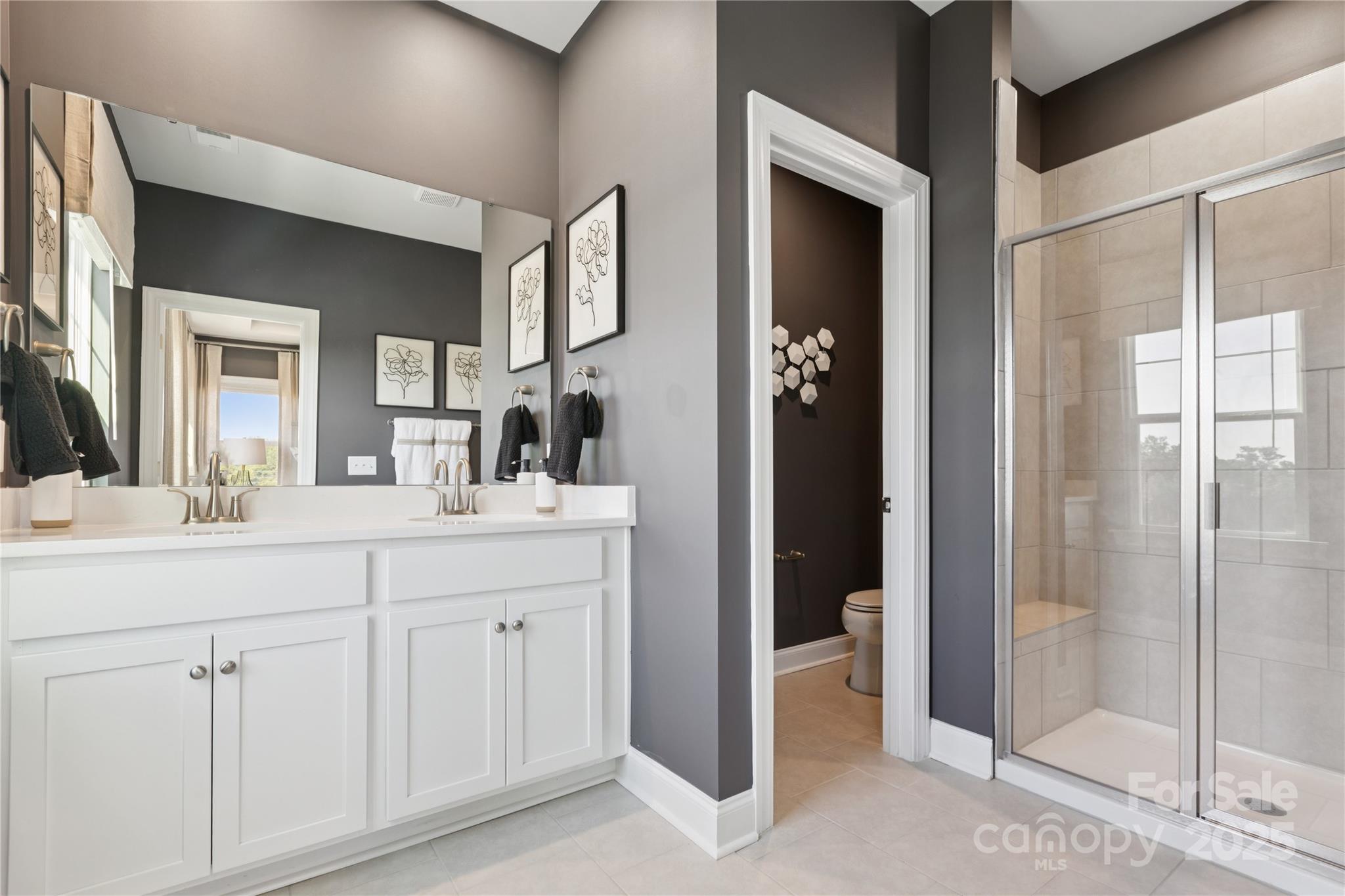 1828 Viewfield Road Fort Mill, SC 29708 - Photo 6 of 33 a bathroom with a double vanity sink and a mirror