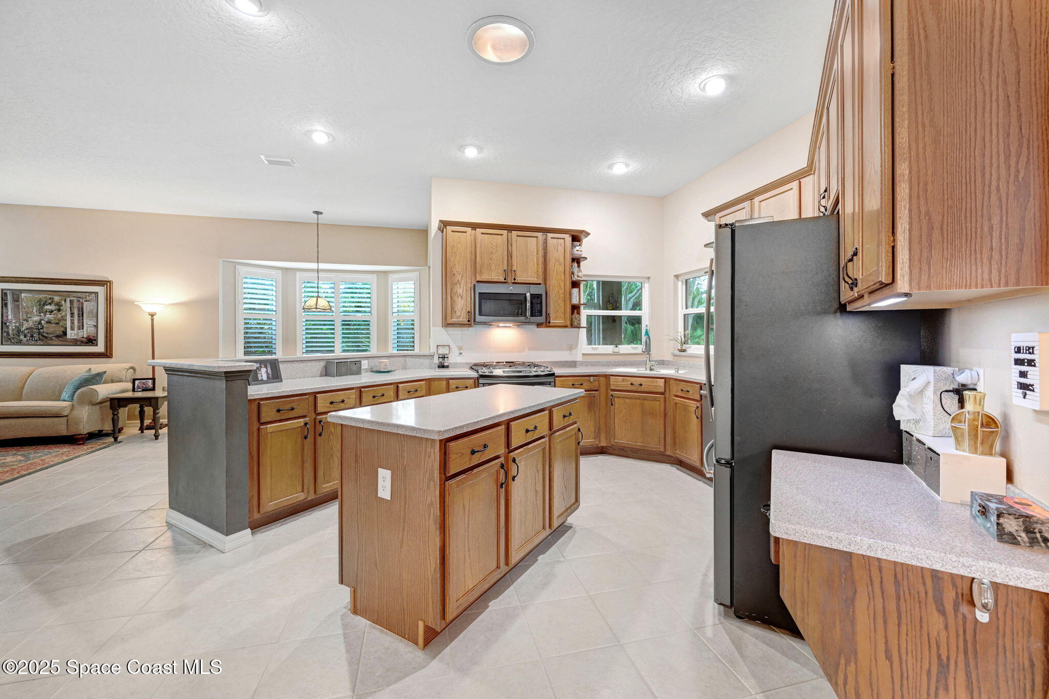 1692 Long Pine Road Melbourne, FL 32940 - Photo 12 of 43 a kitchen with a sink stove and refrigerator