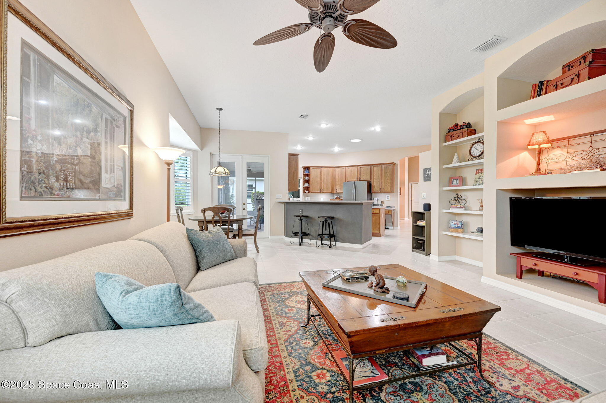 1692 Long Pine Road Melbourne, FL 32940 - Photo 19 of 43 a living room with furniture and a flat screen tv