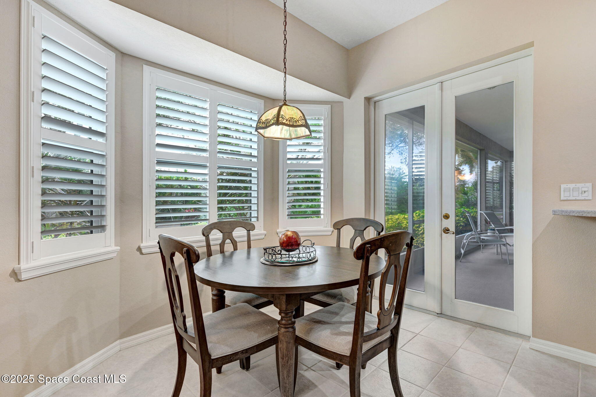 1692 Long Pine Road Melbourne, FL 32940 - Photo 20 of 43 a dining room with furniture a chandelier and wooden floor