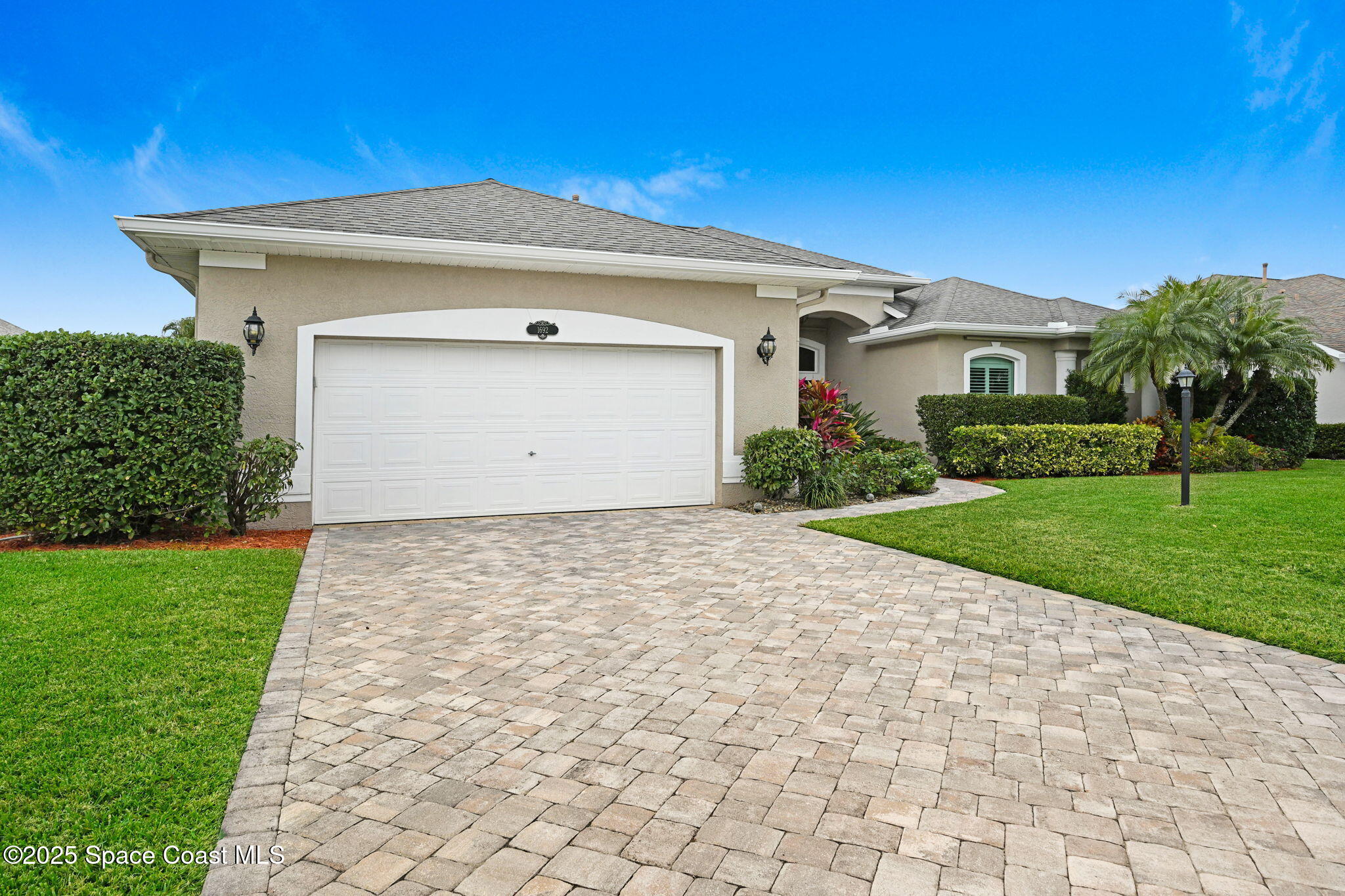 1692 Long Pine Road Melbourne, FL 32940 - Photo 2 of 43 a front view of a house with a yard