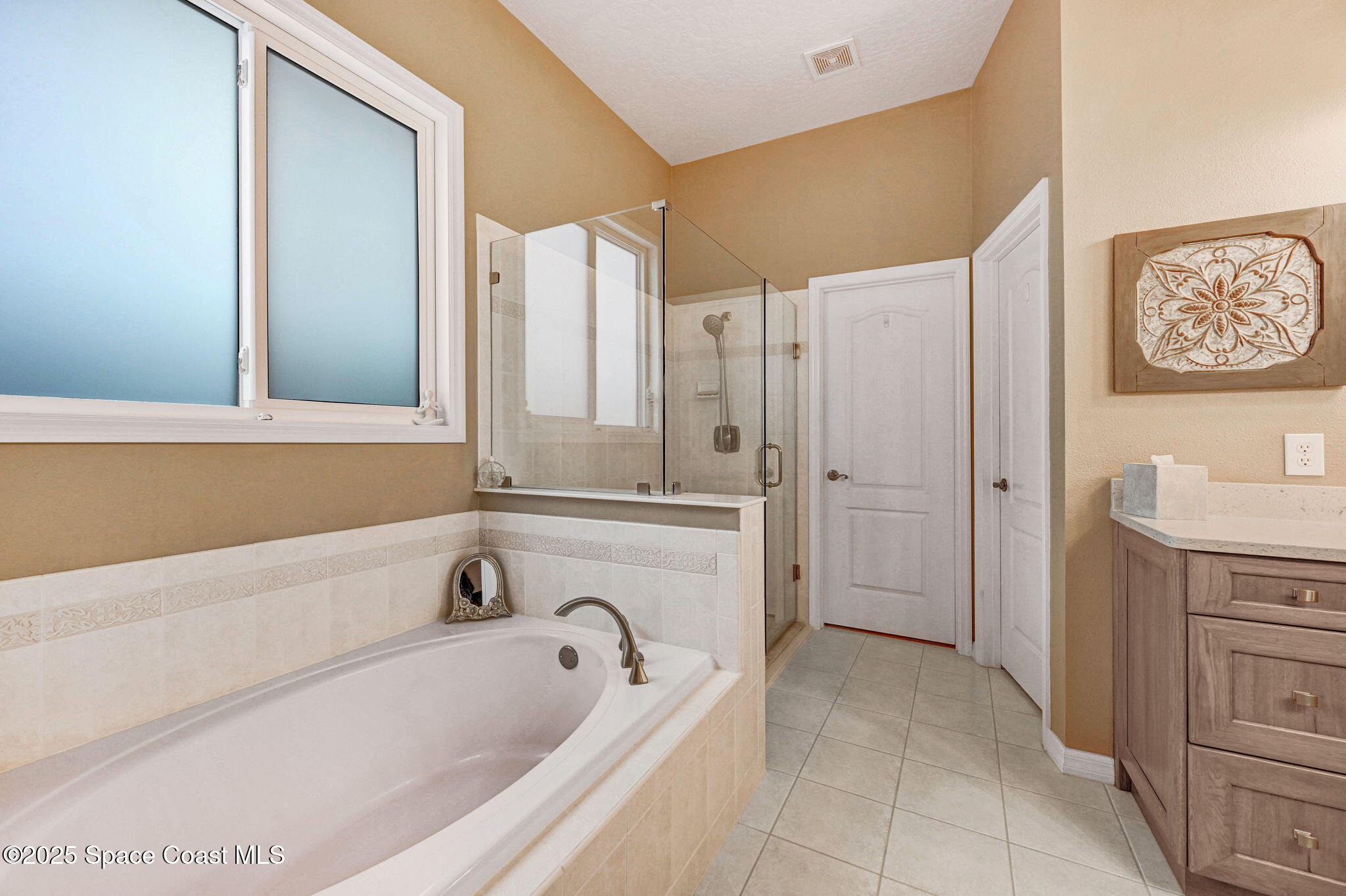 1692 Long Pine Road Melbourne, FL 32940 - Photo 26 of 43 a bathroom with a bathtub a sink and a shower