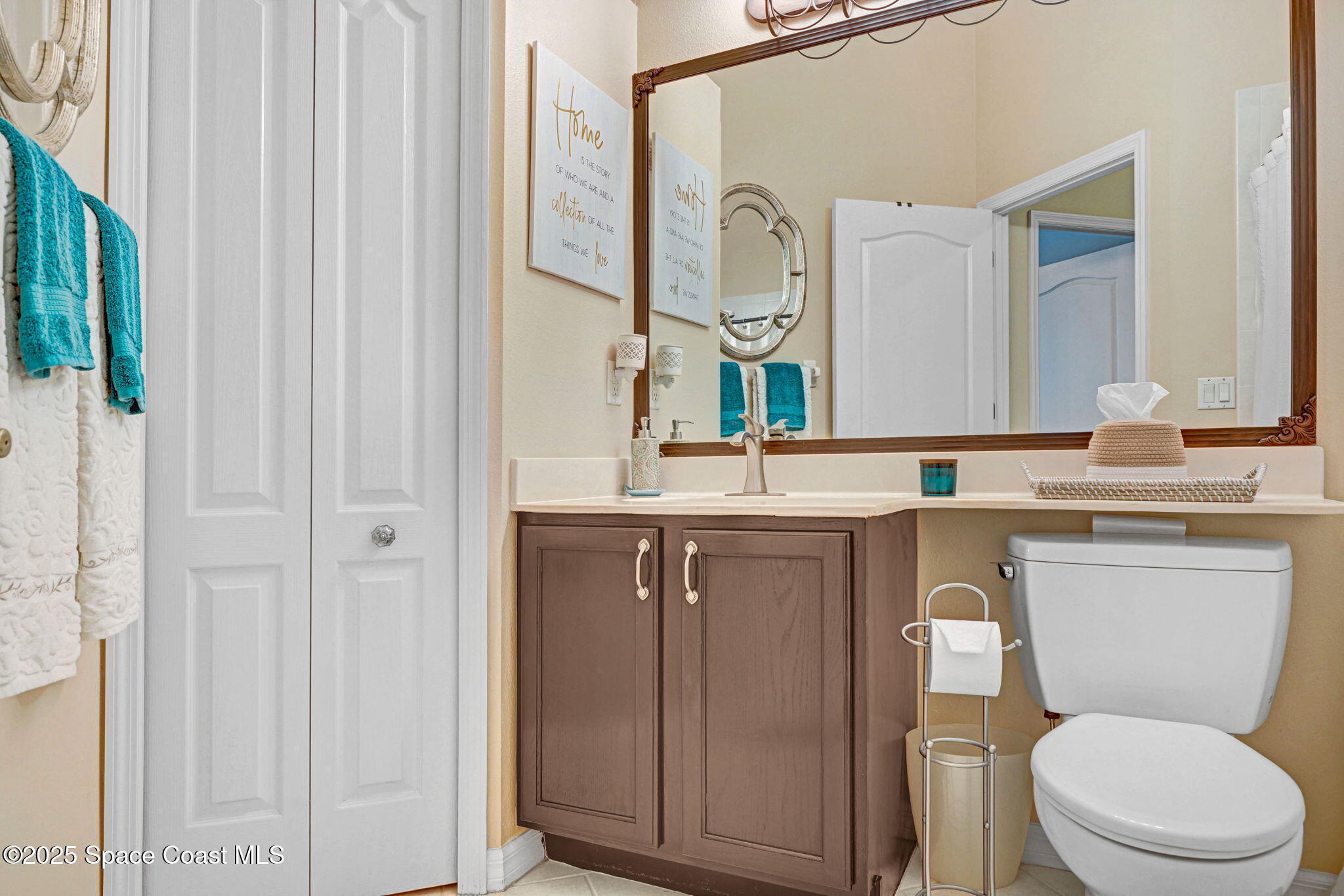 1692 Long Pine Road Melbourne, FL 32940 - Photo 29 of 43 a bathroom with a toilet a sink and a mirror