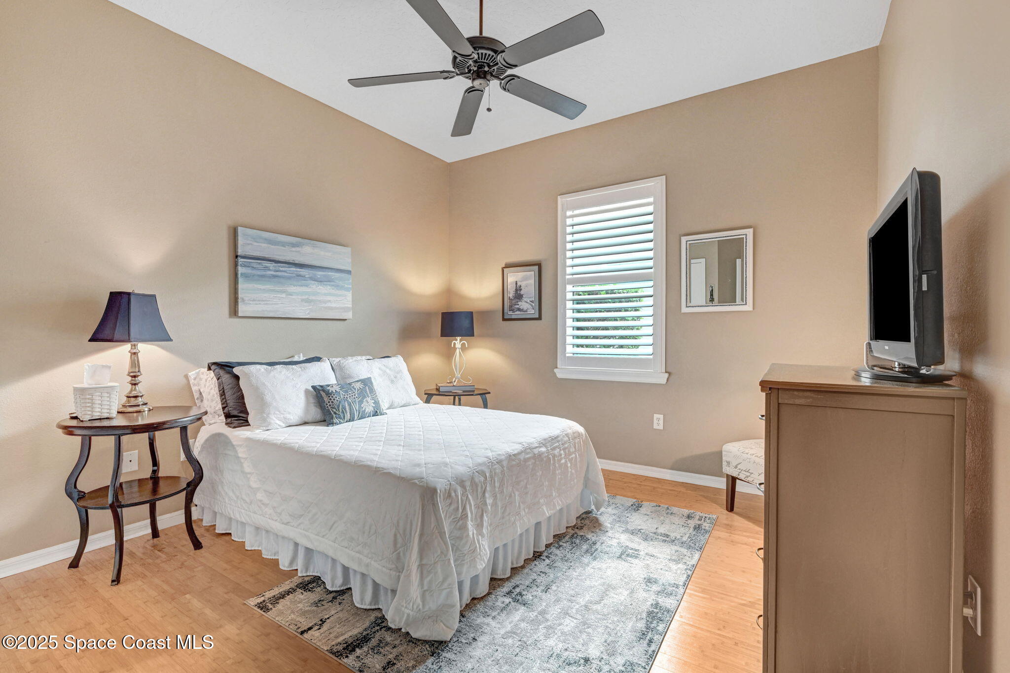 1692 Long Pine Road Melbourne, FL 32940 - Photo 32 of 43 a bedroom with a bed and a flat screen tv