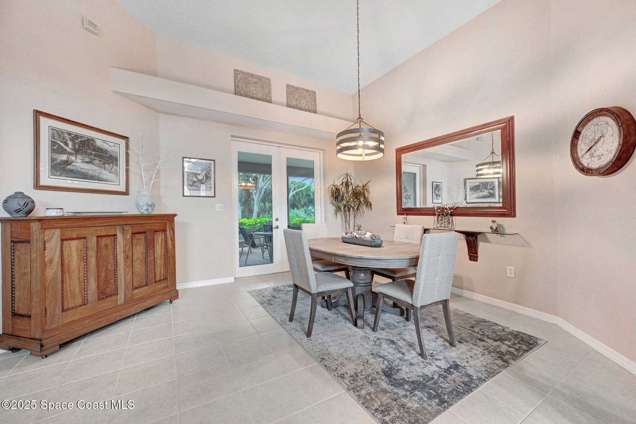 1692 Long Pine Road Melbourne, FL 32940 - Photo 9 of 43 a dining room with wooden floor a chandelier a wooden table and chairs
