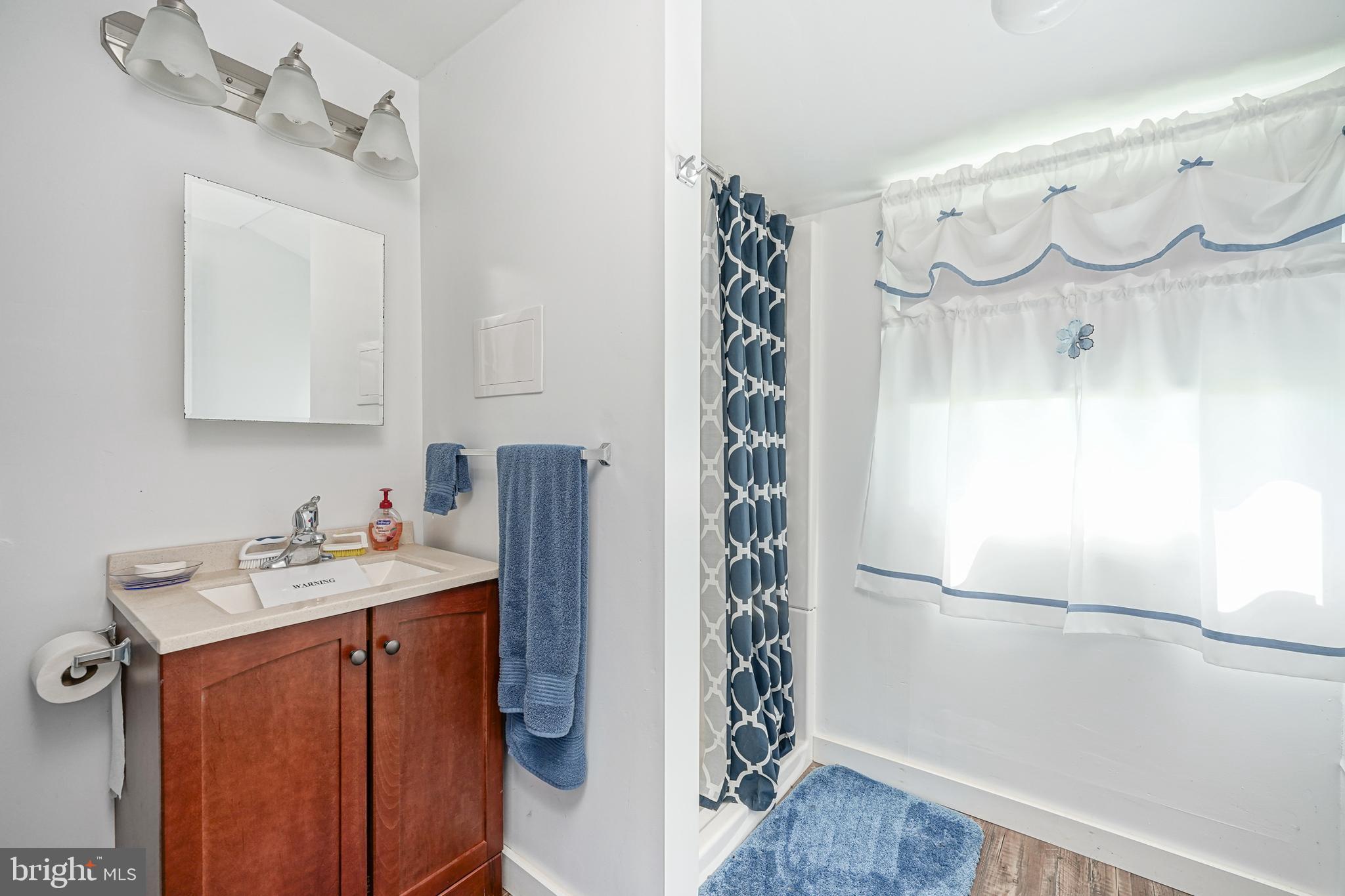 530 Penns Grove Auburn Road Penns Grove, NJ 08069 - Photo 22 of 36 a bathroom with a sink a mirror and a shower