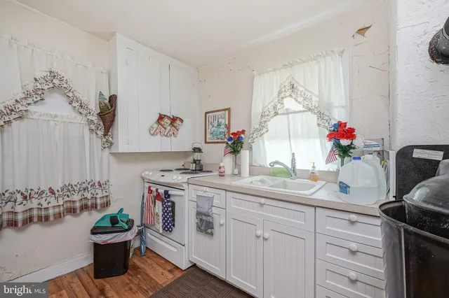 a kitchen with a sink and white cabinets