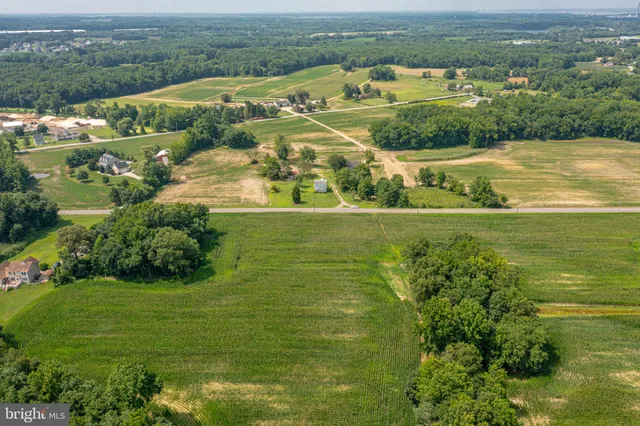 an aerial view of ocean with residential houses with outdoor space and swimming pool