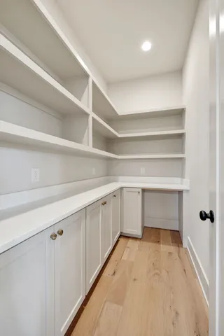 a kitchen with a checkered floor and white cabinets
