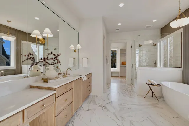 a living room with furniture a chandelier and a table
