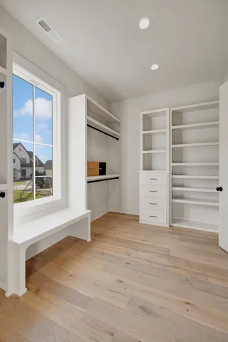 an empty room with a ceiling fan and carpet